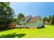 Back of the house exterior shows a large backyard and a deck that's perfect for entertaining at 1201 Teakwood Ct, Sanford, NC 27330