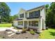 Close up of a charming two-story home with dark shutters, decorative landscaping, and a cozy front porch at 1201 Teakwood Ct, Sanford, NC 27330