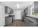 Well-lit kitchen featuring gray cabinets, stainless steel appliances, and a functional layout at 1201 Teakwood Ct, Sanford, NC 27330