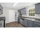 Kitchen features stainless steel appliances, gray cabinets, and modern fixtures at 1201 Teakwood Ct, Sanford, NC 27330