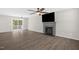 Bright living room features a fireplace, modern ceiling fan, and access to outdoor space at 1201 Teakwood Ct, Sanford, NC 27330