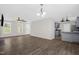 Open-concept living room with wood flooring flows into a kitchen area for easy entertaining at 1201 Teakwood Ct, Sanford, NC 27330