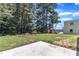 Backyard with lush greenery, a shed, and a newly installed concrete patio at 125 Davis St, Louisburg, NC 27549