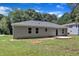 Backyard showcasing newly laid concrete, a home, and ample lawn space at 125 Davis St, Louisburg, NC 27549