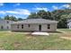Backyard view of a home with a newly installed concrete patio and ample lawn space at 125 Davis St, Louisburg, NC 27549