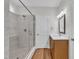 Bright bathroom with marble-tiled shower and glass enclosure at 125 Davis St, Louisburg, NC 27549