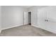 Bedroom featuring carpet, closet, access door, and light neutral walls at 125 Davis St, Louisburg, NC 27549