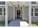 View of the main entrance featuring a classic black front door and white columns at 125 Davis St, Louisburg, NC 27549