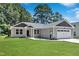 Charming single-Gathering home with well-maintained lawn, garage and inviting curb appeal at 125 Davis St, Louisburg, NC 27549