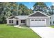 Charming one-story home with a manicured lawn and attached two car garage at 125 Davis St, Louisburg, NC 27549