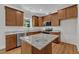 Well-lit kitchen with granite countertops, stainless steel appliances, and custom wood cabinetry at 125 Davis St, Louisburg, NC 27549