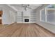 Spacious open living area boasts a cozy fireplace, stylish built-ins, and a ceiling fan at 125 Davis St, Louisburg, NC 27549