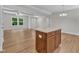 Open-concept living room and kitchen featuring stylish granite island and modern ceiling fan at 125 Davis St, Louisburg, NC 27549