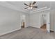 Spacious main bedroom with tray ceiling and neutral carpeting leading to the bathroom and walk-in closet at 125 Davis St, Louisburg, NC 27549
