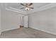 Neutral bedroom with carpeted floors and open doorways to bathrooms and closet spaces at 125 Davis St, Louisburg, NC 27549
