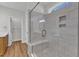 Beautiful marble tiled walk-in shower with glass door and bench at 125 Davis St, Louisburg, NC 27549
