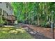Beautiful backyard featuring a wooden deck, plenty of trees, and a well-manicured lawn at 1437 Lindenberg Sq, Wake Forest, NC 27587