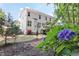 Well-maintained backyard featuring a two-story home, flowering bushes, and plenty of privacy at 1437 Lindenberg Sq, Wake Forest, NC 27587