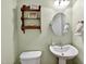 A well-maintained half-bathroom features a pedestal sink, toilet, decorative shelf, and neutral colored walls at 1437 Lindenberg Sq, Wake Forest, NC 27587
