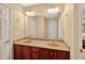 Bright bathroom with double sink vanity, ample counter space, and large mirror enhancing the feeling of spaciousness at 1437 Lindenberg Sq, Wake Forest, NC 27587