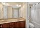 Well-lit bathroom featuring double vanity, ample storage, and a shower-tub combo for added convenience at 1437 Lindenberg Sq, Wake Forest, NC 27587