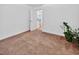 Spacious carpeted bedroom with a view to the hallway and a bright plant to add a touch of green at 1437 Lindenberg Sq, Wake Forest, NC 27587