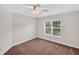 Clean and simple carpeted bedroom with bright natural light from a large window overlooking a green yard at 1437 Lindenberg Sq, Wake Forest, NC 27587