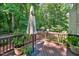 Outdoor deck features wood flooring, railing, potted plants, and an umbrella providing ample shade at 1437 Lindenberg Sq, Wake Forest, NC 27587
