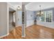 Elegant dining room featuring hardwood floors, wainscoting, a chandelier, and abundant natural light at 1437 Lindenberg Sq, Wake Forest, NC 27587
