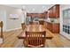 A spacious dining area has a long wooden table with chairs, hardwood floors, and a large window for natural light at 1437 Lindenberg Sq, Wake Forest, NC 27587
