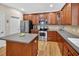 Modern kitchen with stainless steel appliances, custom cabinetry, and a center island for food preparation at 1437 Lindenberg Sq, Wake Forest, NC 27587