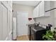 The laundry room is equipped with modern appliances, white cabinets, and neutral paint, and has ample storage at 1437 Lindenberg Sq, Wake Forest, NC 27587