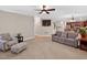Inviting living room with neutral carpet, a comfortable sofa, and views into the adjoining kitchen and dining area at 1437 Lindenberg Sq, Wake Forest, NC 27587