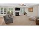 Spacious living room with a fireplace, large windows, plush carpeting, and comfortable seating at 1437 Lindenberg Sq, Wake Forest, NC 27587