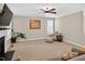 Bright living room featuring plush carpeting, a fireplace, comfortable seating, and a large TV at 1437 Lindenberg Sq, Wake Forest, NC 27587