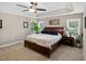 Spacious main bedroom with tray ceiling, carpet flooring, windows, and plant which brings brightness to the room at 1437 Lindenberg Sq, Wake Forest, NC 27587