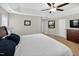 A spacious primary bedroom has tray ceilings, neutral walls, carpet, and features a ceiling fan and recessed lighting at 1437 Lindenberg Sq, Wake Forest, NC 27587