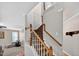 A carpeted staircase with wooden banisters adds to the charm of this home at 1437 Lindenberg Sq, Wake Forest, NC 27587