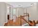 The upstairs landing has hardwood floors, white railings, and multiple doorways leading to various rooms at 1437 Lindenberg Sq, Wake Forest, NC 27587