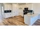 Bright kitchen features stainless appliances, white cabinets, dark backsplash and a center island at 1563 Wendell Valley Blvd, Wendell, NC 27591