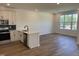 The kitchen flows into the living space and includes stainless steel appliances and a center island at 1563 Wendell Valley Blvd, Wendell, NC 27591