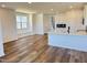 Open-concept living space with wood floors and a window seat overlooking the kitchen at 1563 Wendell Valley Blvd, Wendell, NC 27591