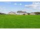 Spacious backyard with lush green lawn and neighboring homes, offering a peaceful setting at 174 Arrow Ln, Middlesex, NC 27557