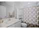Bathroom with a white vanity, decorative shower curtain, and built-in storage at 174 Arrow Ln, Middlesex, NC 27557