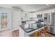 Bright kitchen featuring stainless steel appliances and white cabinetry at 174 Arrow Ln, Middlesex, NC 27557