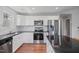 Modern kitchen with stainless steel appliances and dark granite countertops at 174 Arrow Ln, Middlesex, NC 27557