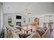 Spacious living room with hardwood floors, fireplace, and an abundance of natural light at 174 Arrow Ln, Middlesex, NC 27557