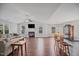 Open-concept living area featuring a fireplace, hardwood floors, and large windows at 174 Arrow Ln, Middlesex, NC 27557