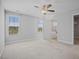 Large Primary bedroom with carpet, plenty of light, and an en-suite bathroom and walk-in closet at 174 Arrow Ln, Middlesex, NC 27557