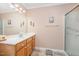 Bathroom with a single sink vanity, large mirror, and shower stall with a glass door at 1822 Atterbury Ln, Durham, NC 27712